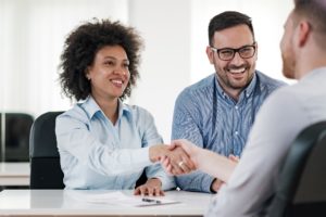 happy clients shaking hands in a meeting
