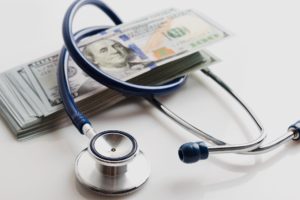 dollars with stethoscope around them