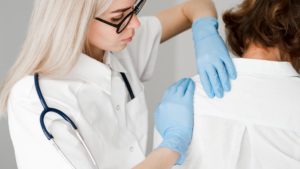 doctor with gloves examining a shoulder injury